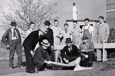 1941-10-22 photograph of Dairy Science Building l-r: William Davidson, Dean Iddings, Dr. Theophilus, President Dale, William Thomas, William Lind. Dairy students in background. Rudd, a carpenter, on roof.
