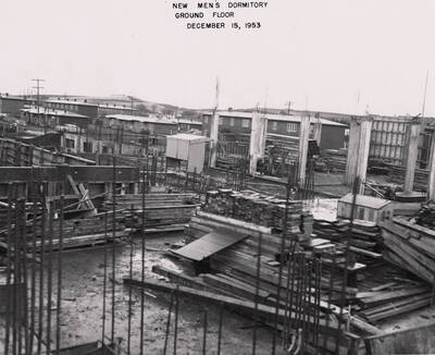 December 15, 1953 photograph of Gault Hall under construction. Planks of wood in the foreground.