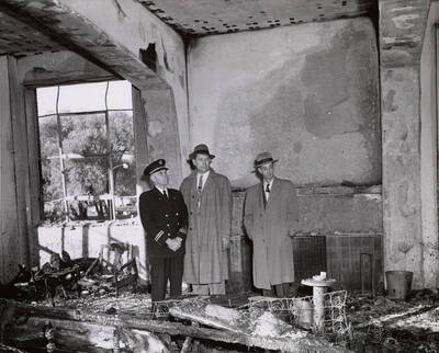 1956 photograph of Gault Hall Left to right: Moscow Fire Chief Carl Smith, underwriter's official Thor Fledstad, and Washington state deputy fire marshal Leonard Burgunder.