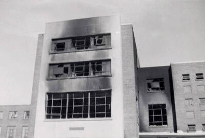 1956 photograph of Gault Hall. Fire damage is evident on the exterior of the building. Donor: Maurice Johnson.