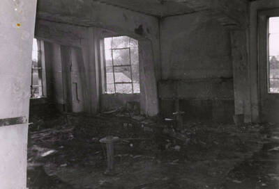 1956 photograph of Gault Hall. Interior photo of a lounge after a fire. Donor: Maurice Johnson.