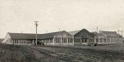 1924 photograph of the Engineering laboratories. Utility poles around the building.