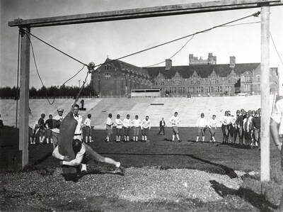 1923 photograph of MacLean Field. Administration Building in background. Charlie Erb coaching student athletes.