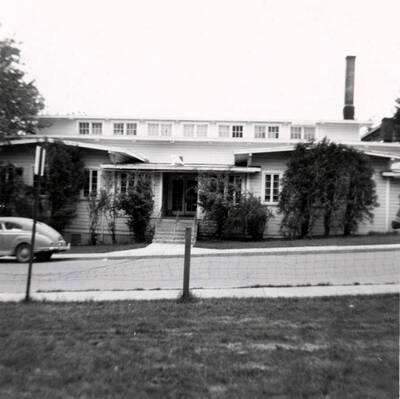 May 1, 1952 photograph of the University Hut Post Office at Line Street and University Avenue. Automobile in foreground. Donor: Gary Cox.