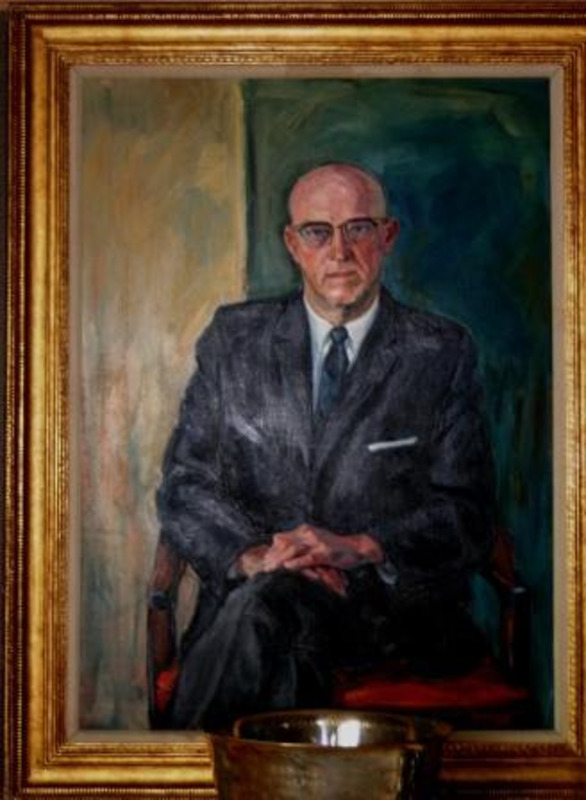 Portrait painting of Dr. Donald R. Theophilus displayed in a gilt wood frame with inscription plaque.