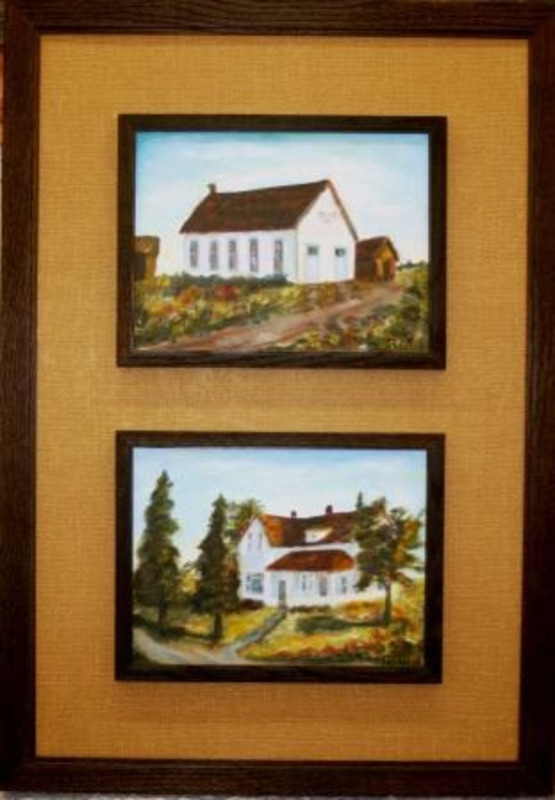 Two individually framed paintings of white houses framed together in a larger brown frame with yellow matting.