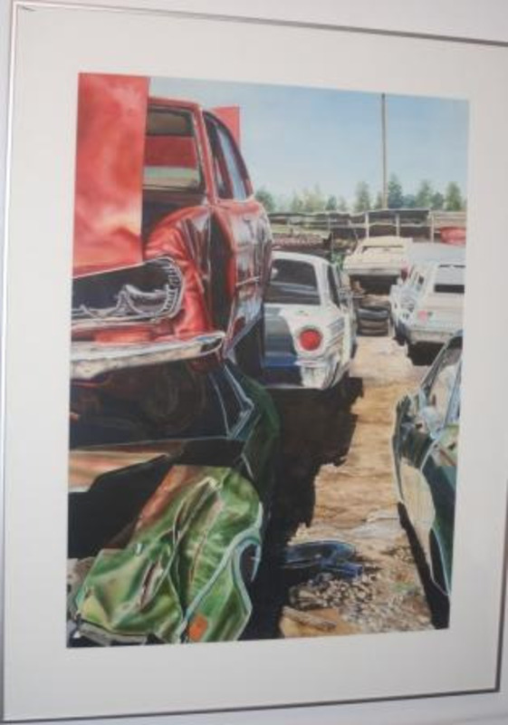Watercolor painting of cars stacked on top of one another in a lot. The piece is matted in white and in a thin silver metal frame.