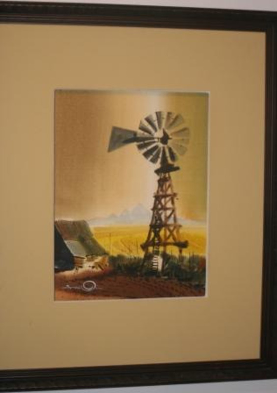Watercolor painting depicting a windmill and part of a building against a yellow background. This piece is matted in yellow and in a dark brown frame.