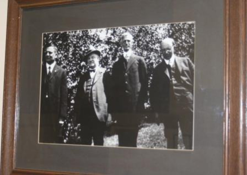 Black and white photograph of Ernest H. Lindley and three other men. This piece is framed and displayed under glass.