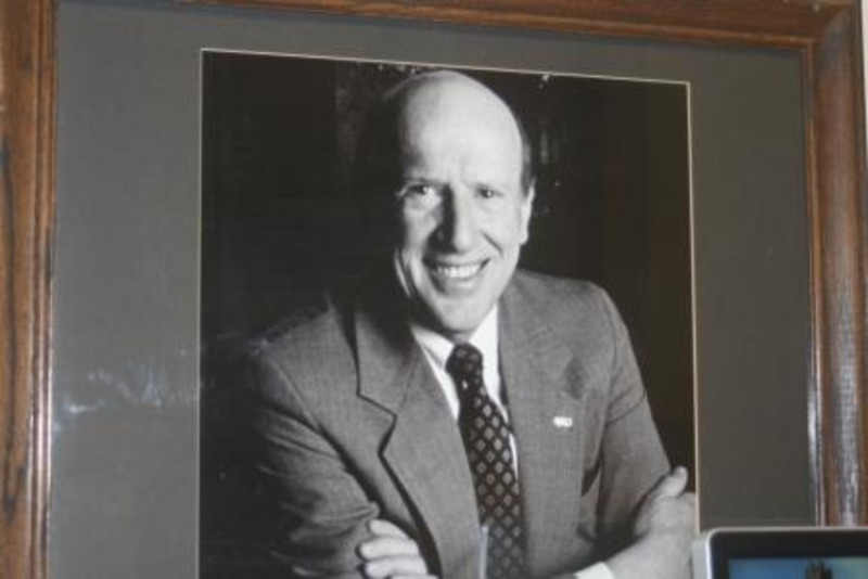 Black and white photograph of Richard D. Gibb, president of the University of Idaho 1977–1989. Displayed under glass in a wooden frame.