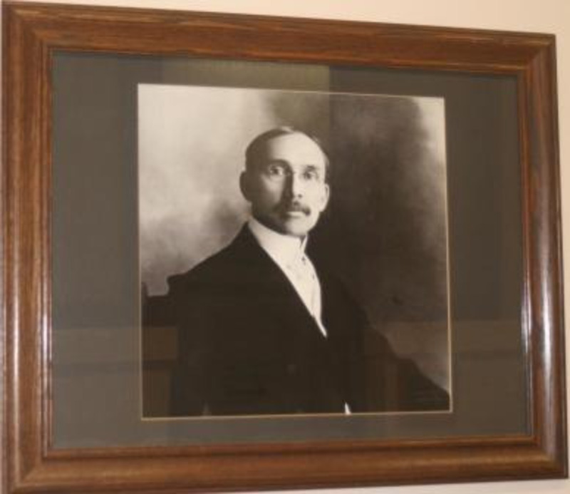 Black and white photograph of James H. Forney, acting president of the University of Idaho 1891-1892. Displayed under glass in a wooden frame.