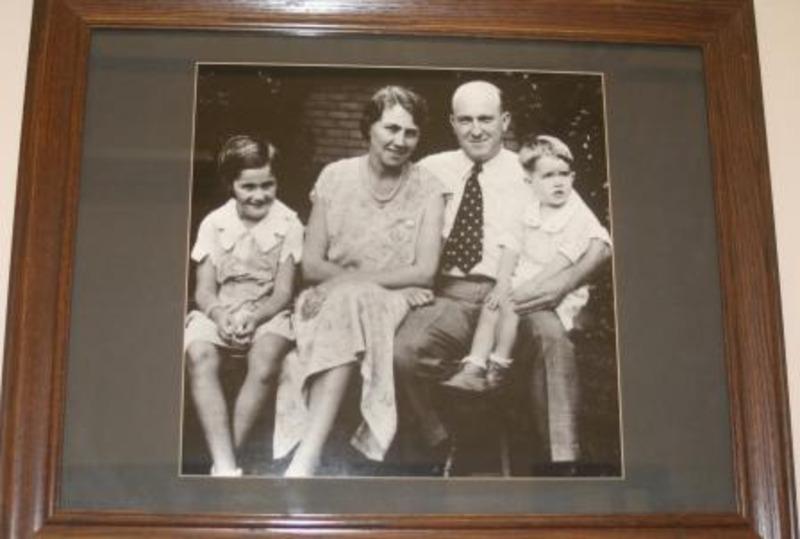 Black and white photograph of Donald R. Theophilus, president of the University of Idaho 1954-1965, and his family. Displayed under glass in a wooden frame.