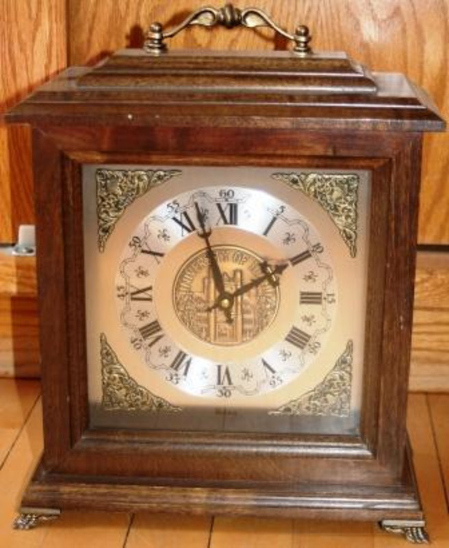 Ornate clock made from metal, wood and glass. An inscription on the clock face reads "University of Idaho."