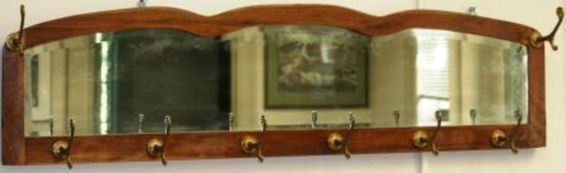 Hat rack with ten hooks and a mirrored plate mounted to the wooden board.