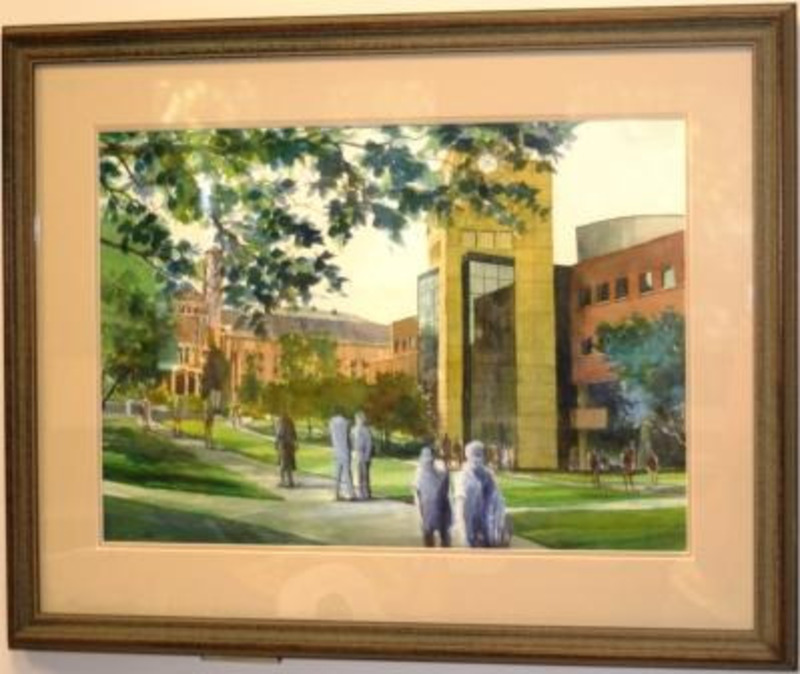 Painting showing students walking outside the University of Idaho Library with the Memorial Gymnasium in the background. Displayed using a cream matte in a brown wooden frame.