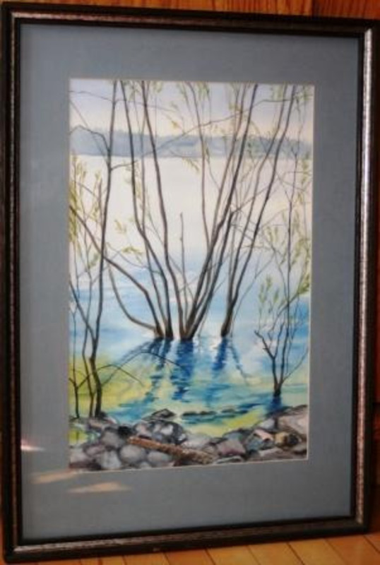 Painting showing thin trees and reeds at the shore of a lake. Displayed using a blue matte in a thin wooden frame.