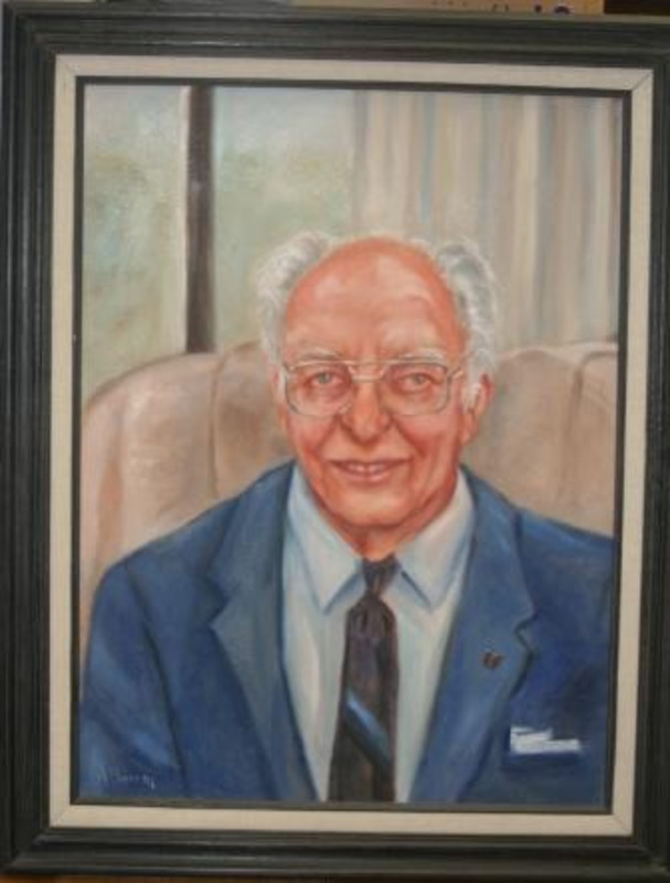Portrait painting of Dr. Boyd A. Martin displayed in a dark wooden frame.