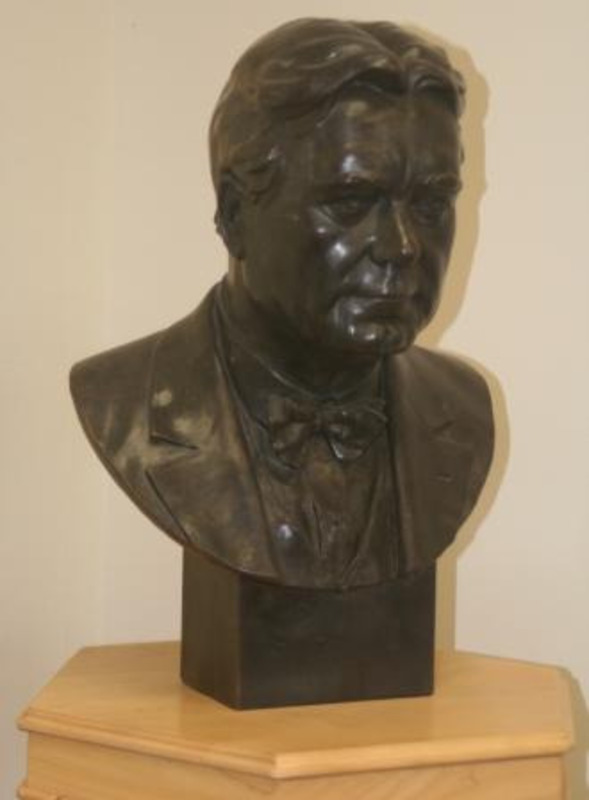 Bronze bust of  William Edgar Borah displayed on a wooden pedestal.