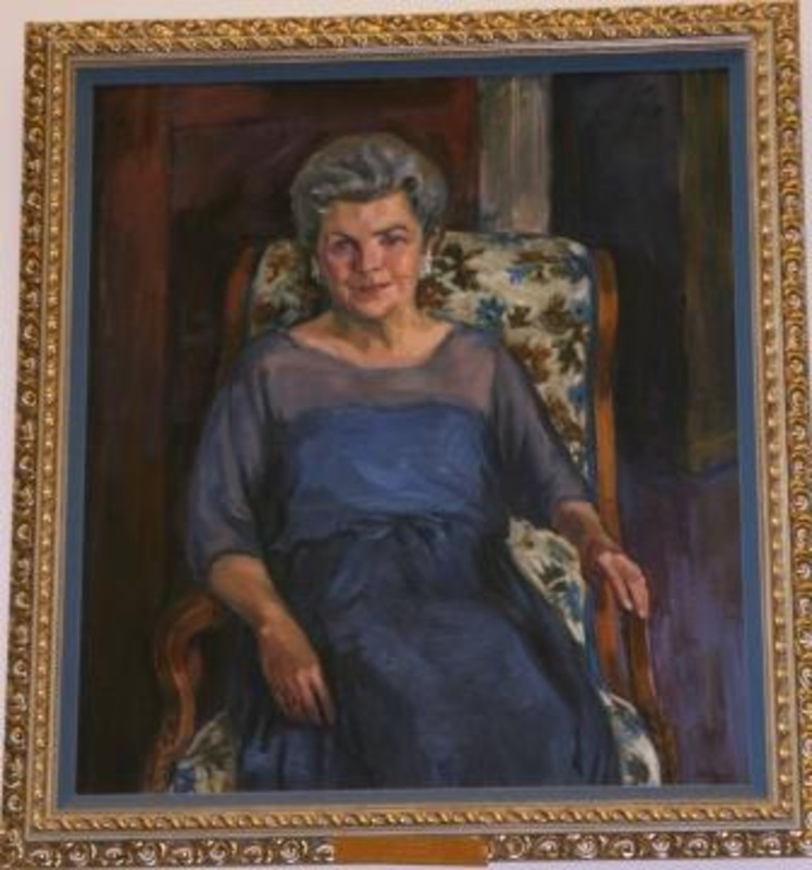 Painted color portrait of Law Librarian Carolyn Folz displayed in an ornate gilt frame.