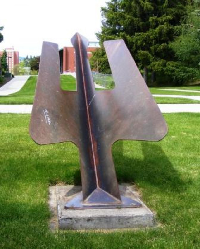 Sculpture of a three pronged shape rising out of the ground made from welded and brazed steel.