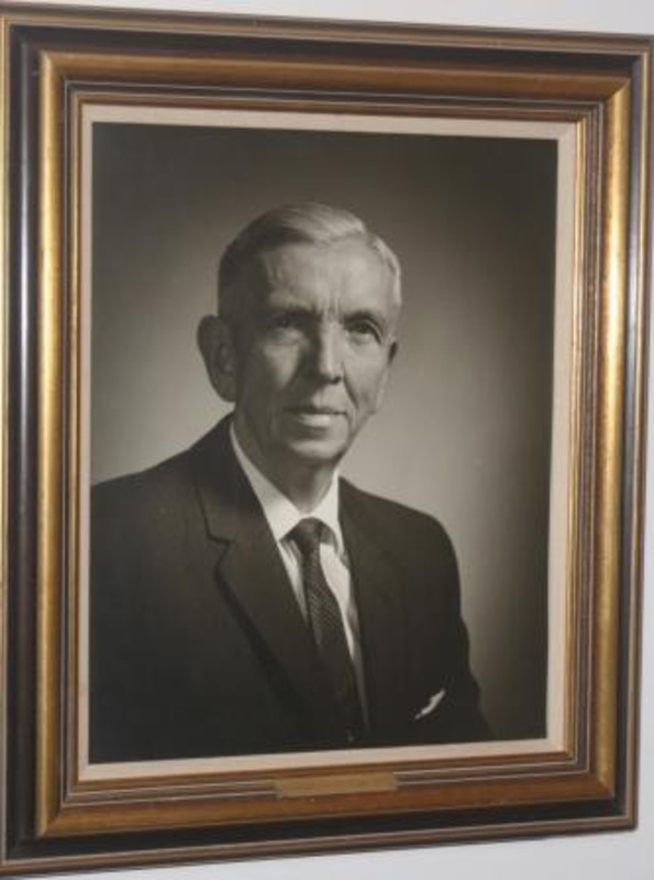 Black and white portrait photograph of Theodore Jan Prichard. Displayed with a small plaque in and ornate black and gold frame.
