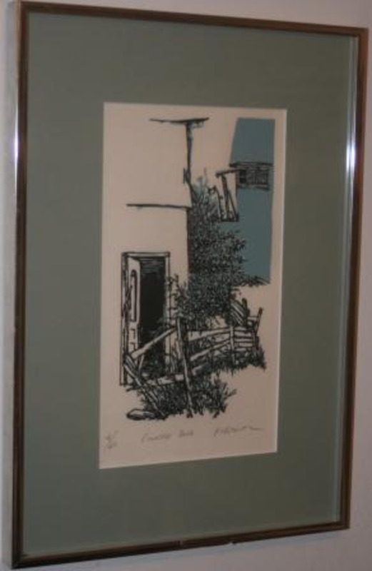 Block print showing and open door in a white wall next to a dilapidated fence and overgrown grass and bushes. Displayed using a cream matte in a silver frame. Labeled as print #4 of60.