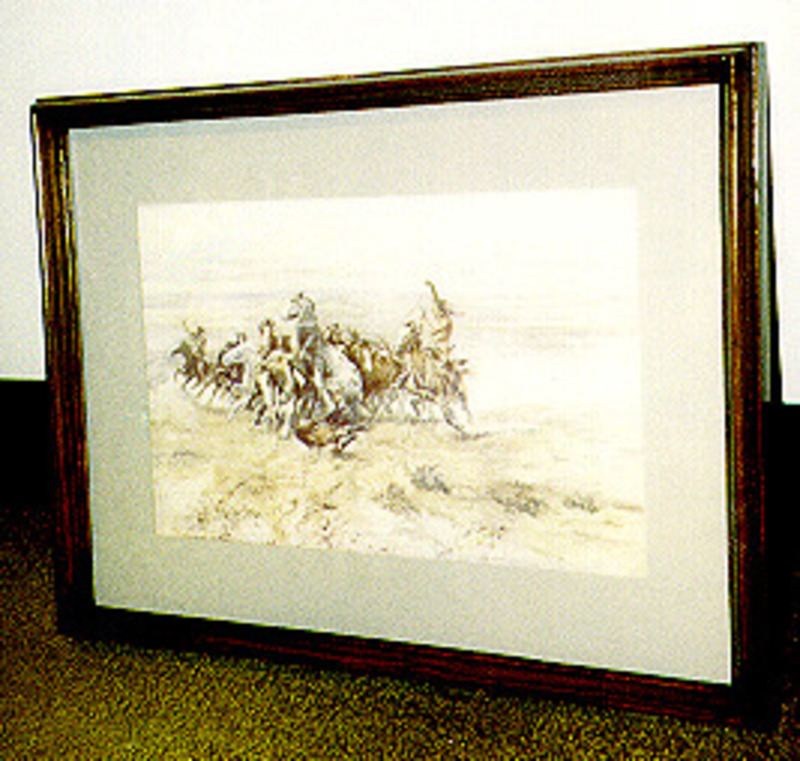 Print showing people riding horses across plains. Displayed under glass using a gray mat in a wooden frame.