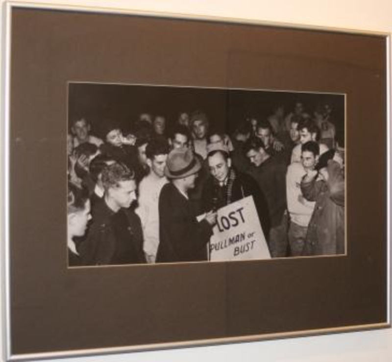 Black and white photograph showing a crowd of people around a man holding a sign that reads "Lost Pullman or Bust."