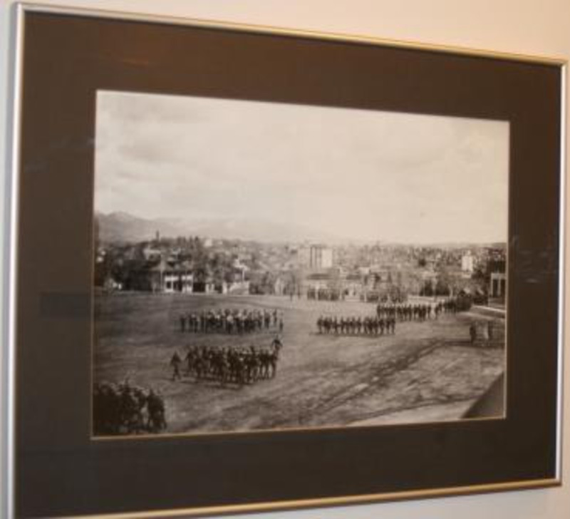 Black and white photograph showing uniformed people in formation in a field on the University of Idaho campus.