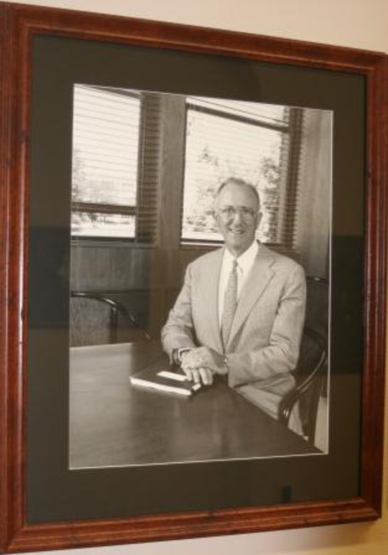 Black and white photograph of Gary G. Michael, interim President of the University of Idaho 2003-2004 The photograph is displayed with a black matte in a wooden frame.