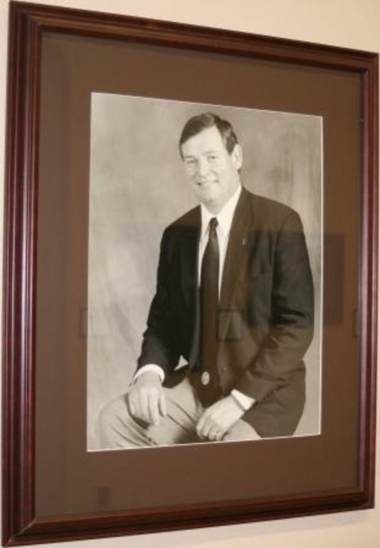 Black and white photograph of Timothy P. White, President of the University of Idaho 2004-2008. The photograph is displayed with a black matte in a wooden frame.