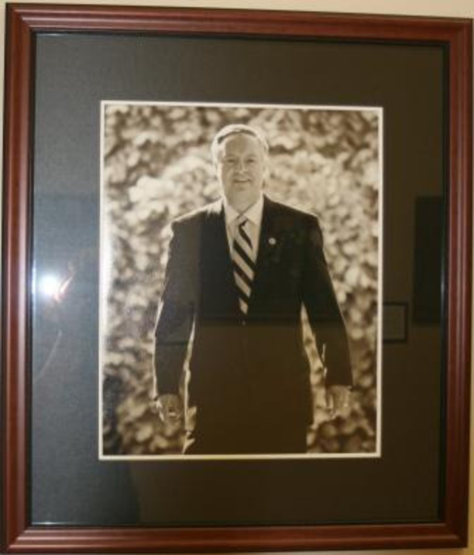 Black and white photograph of M. Duane Nellis, President of the University of Idaho 2009-2013. The photograph is displayed with a black matte in a wooden frame.