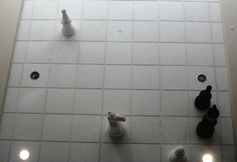 Sculpture of mixed media using chess pieces on square ceiling tiles to create a chess game in progress. This was created as a class specific assignment for Art121 in 2006.