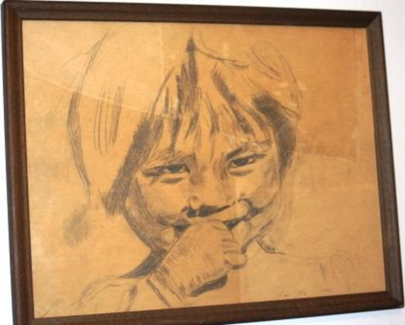 Pencil drawing of an Inuit child on brown paper. Framed without a matte.