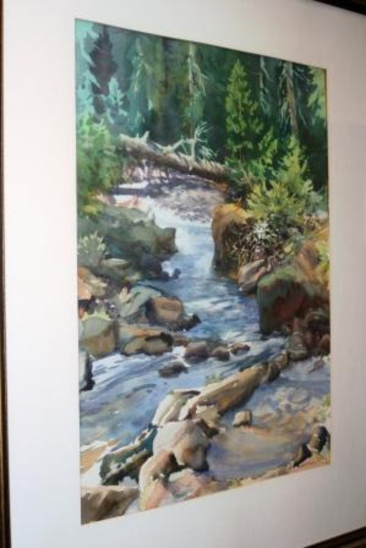 Painting of a river flowing over rocks and fallen trees in a pine forest. The painting has a cream matte and gold frame.
