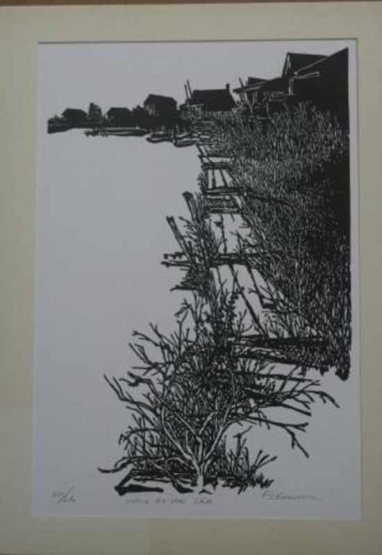 Woodcut print of a boardwalk with houses in background.  Signed by Shirley Caldwell and labeled "217/250"