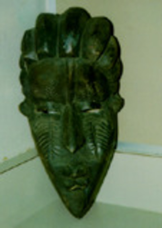 Carved wooden mask with a painted chin.