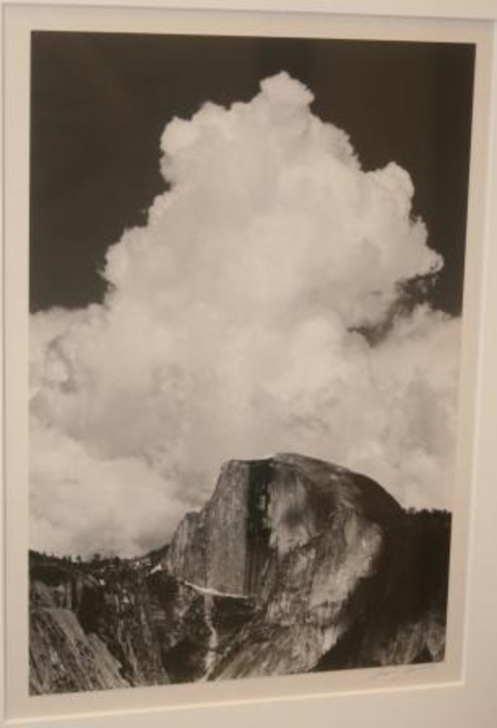 Photograph of a thundercloud building above Half Dome in Yosemite National Park.