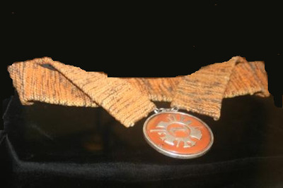 Medallion made from wool, silver, jasper, and wood.