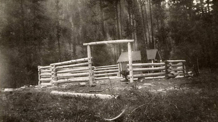 A corral in the process of being constructed. Writing below the photo reads: 'The corral'.