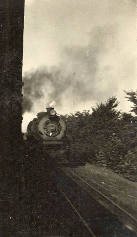 Photo of a railroad engine coming down the tracks as the photographer's train passes it.