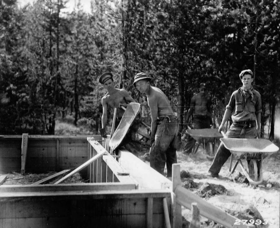 Four CCC boys pouring the cement for the guard station at Redfish Lake in the Sawtooth National Forest, Idaho.