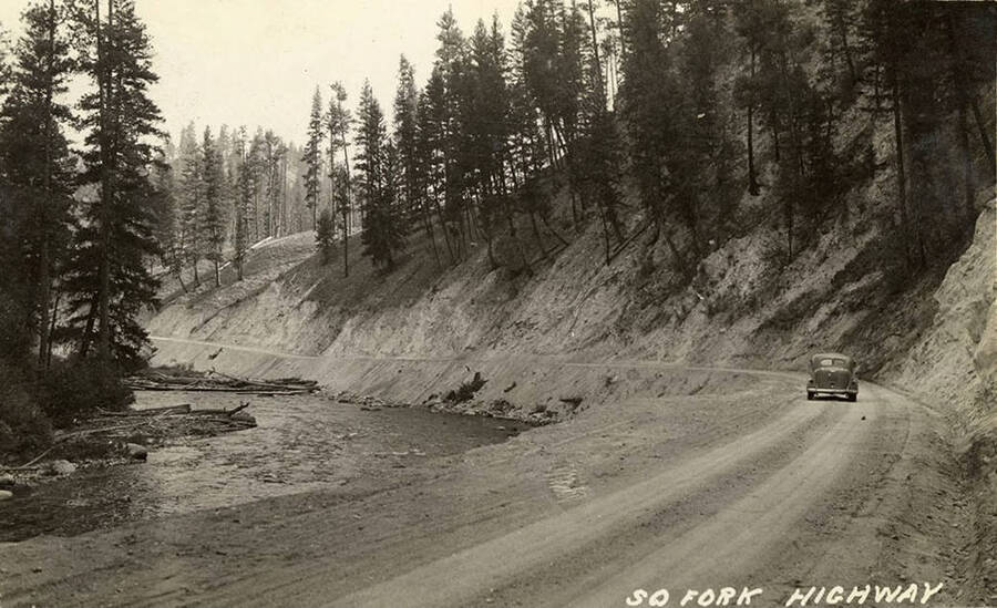 Photo of the highway along the river and a car driving on it. Writing on the photo reads: 'So. Fork Highway'.