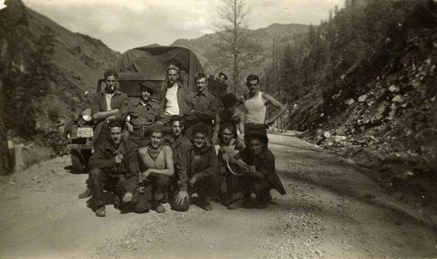 Photo of a CCC work crew in front of truck on a rocky road.