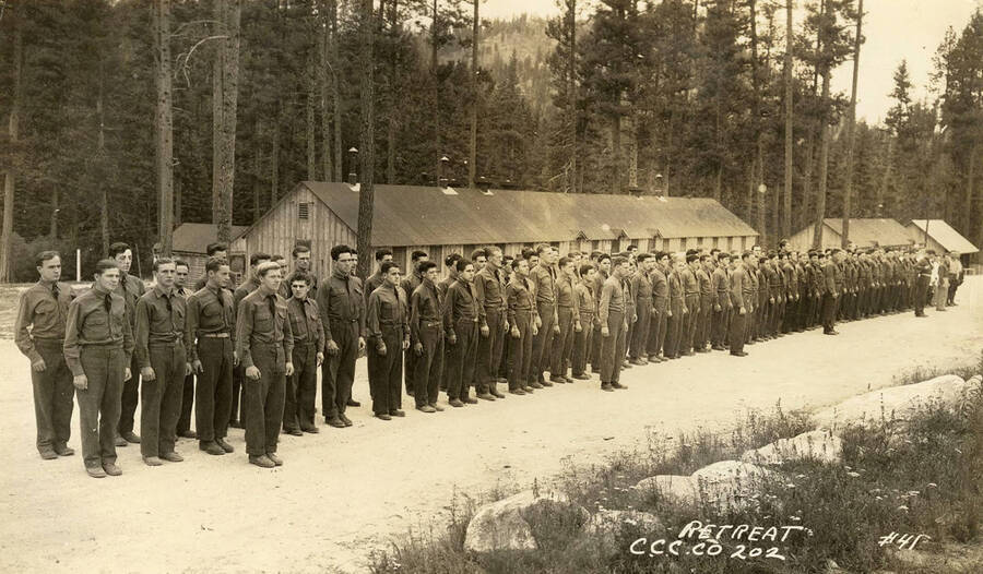 CCC Company 202 in formation at sundown for the retreat of the flag. Writing on the photo reads: 'Retreat C.C.C. Co. 202 #41'.
