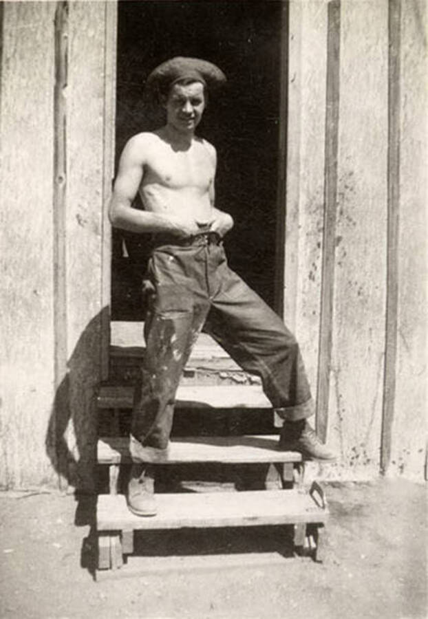 Photo of a CCC man posing on the steps to a barrack. Writing under the photo reads: 'Nickerson'.