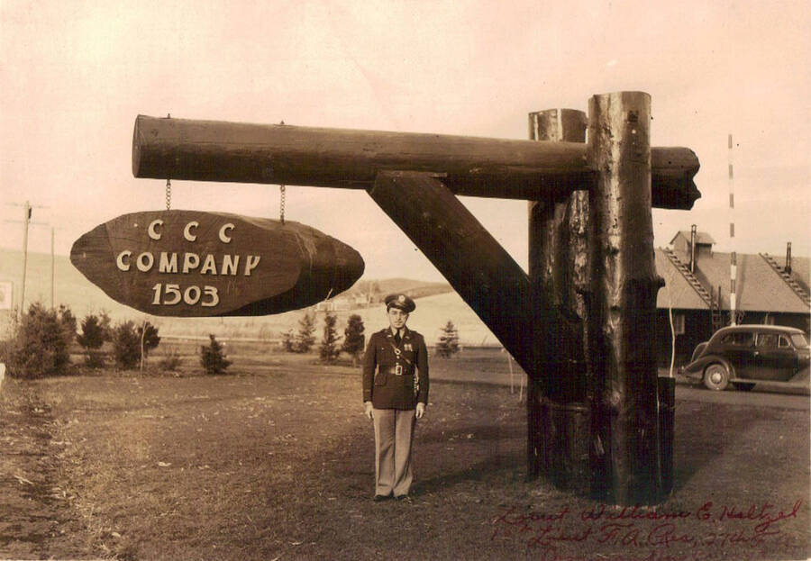 Photo of Lieutenant William G. Haltzel, Co. Commander and CCC camp sign. The sign reads: 'CCC Company 1503'. There is some writing in red ink at the bottom of the photo.