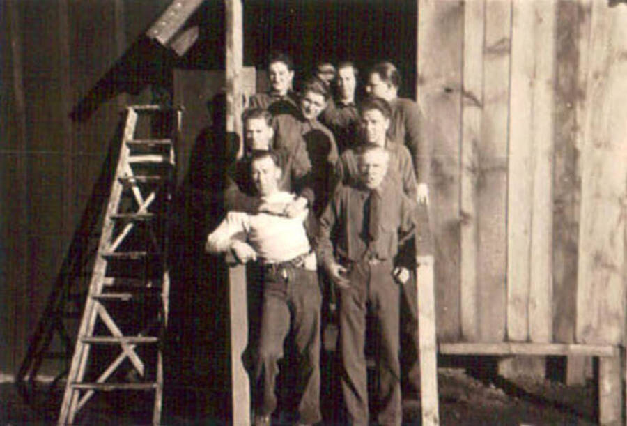 Group photo in front of a CCC barrack with a ladder leaning against the side. Writing to the right of the photo reads: 'Some of the Boys.'