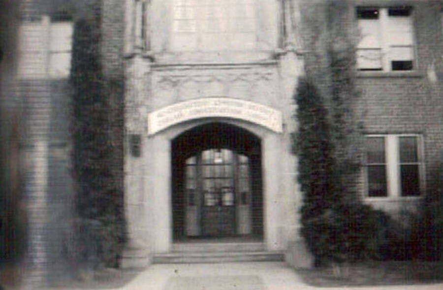 Blurry photo of the CCC District Headquarters at the Lewiston State Normal School. Writing under the photo reads: 'Headquarters'.