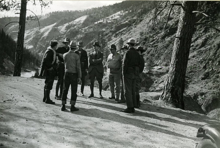 National Geographic and CCC staff from CCC Companies 251 and 283 standing on a road in front of a river valley.